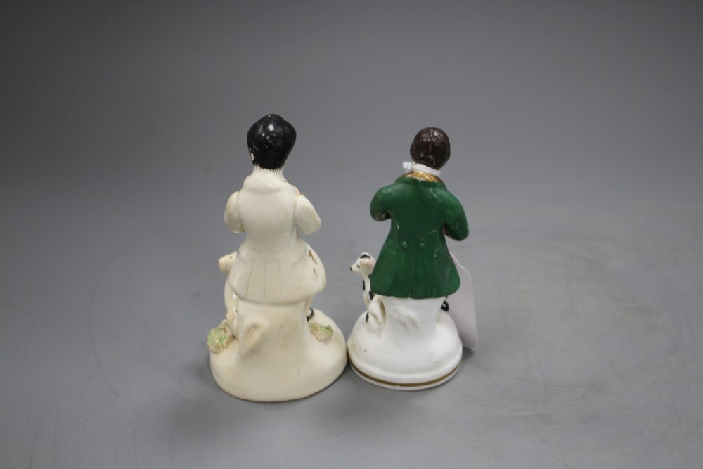 Two Staffordshire porcelain figures of musicians seated by a dog, c.1840-50, H. 11.5 - 12cm